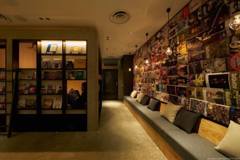 Sleeping compartments set into and behind tall bookshelves in a quiet room
